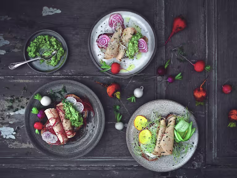 Quorn Spinach and Red Pepper Slices served on sliced bread with beetroot, radish and cress on a table scattered with radishes