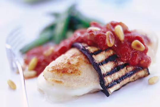 Quorn Vegetarian Fillets with aubergine, mozzarella, tomato, onion, balsamic vinegar and pine nuts, served on a plate