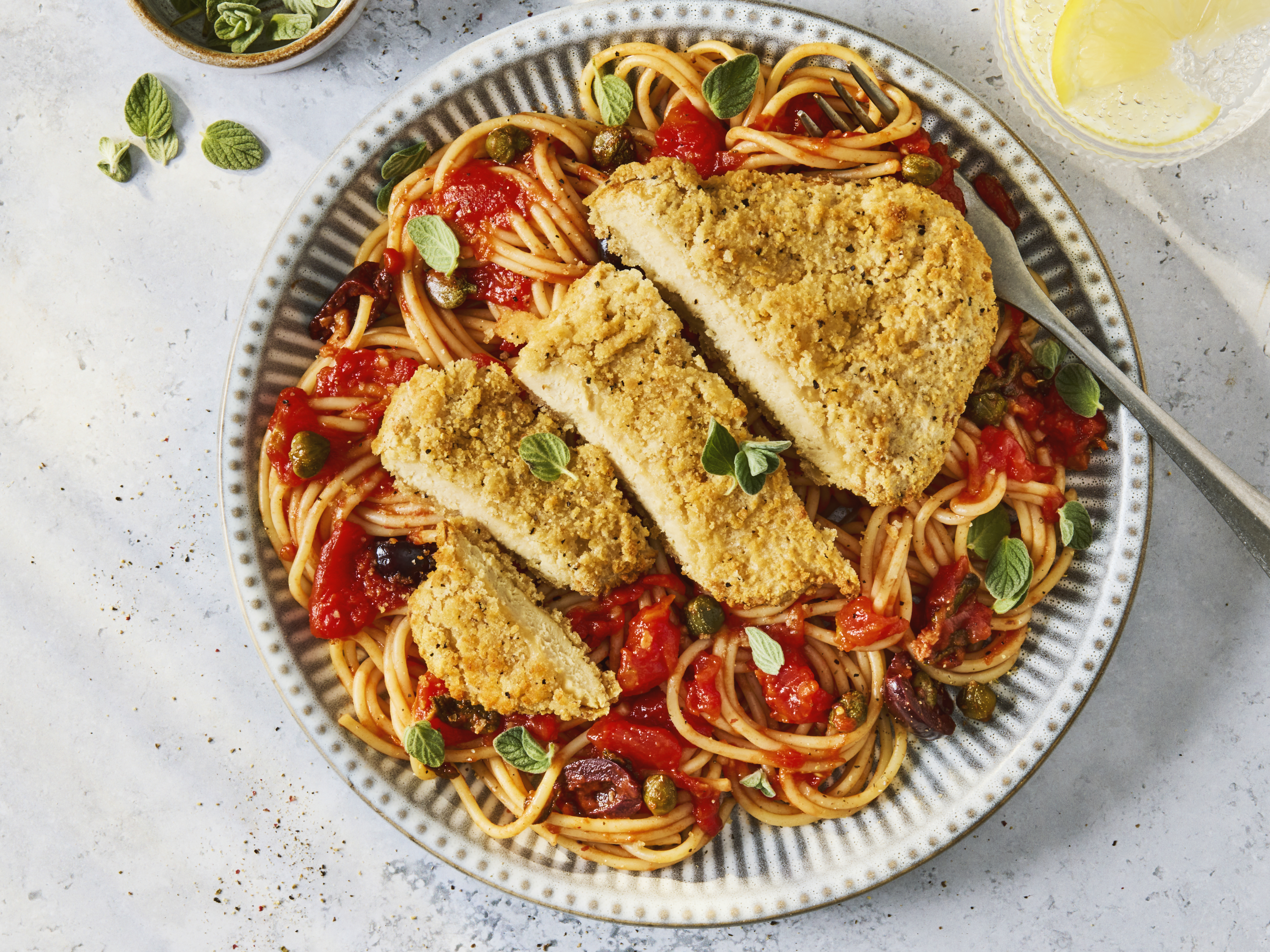 Close-up product image of the Quorn NEW Lemon & Pepper Schnitzels 220g pack, using the distinct split orange and teal packaging seen in other Quorn lines.