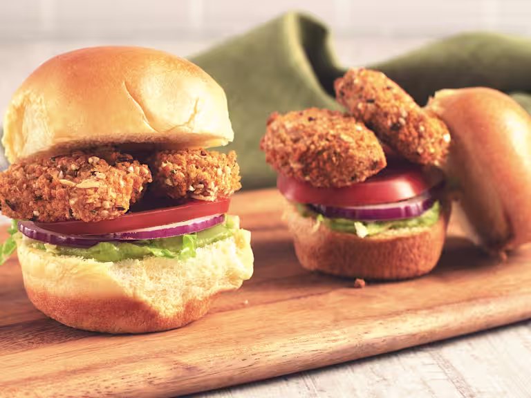 Veggie burger recipe made with Quorn Vegan Crunchy Nuggets and salad served on a wooden tray