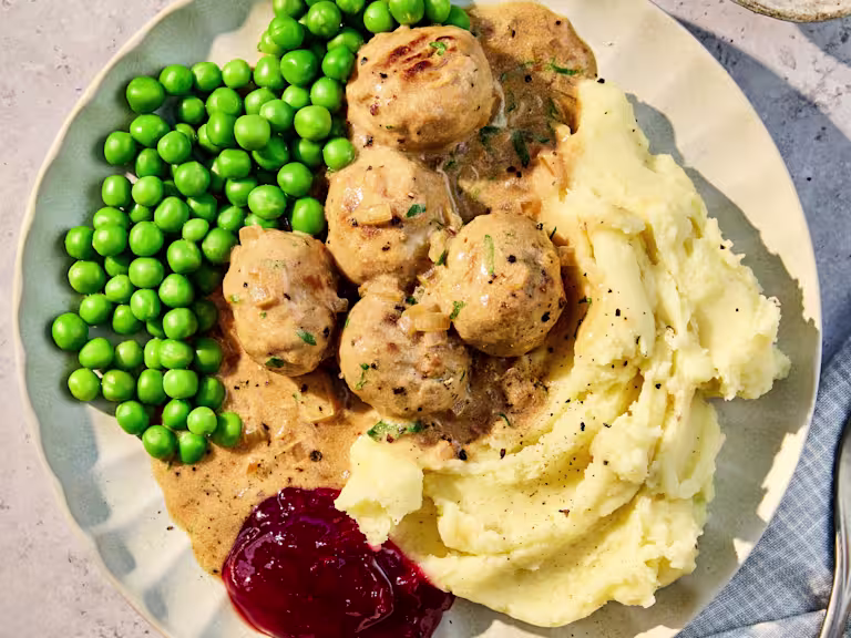 Plate of meat-free Quorn Swedish Style Balls made with Quorn Balls, served with mashed potatoes, peas and creamy gravy.