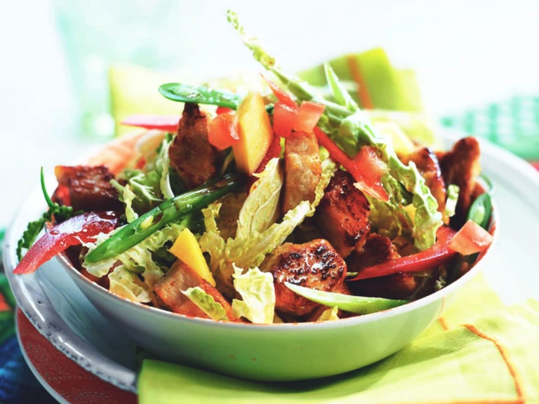 A bowl of Thai salad with marinated Quorn pieces, beans, peppers, chili and mango.