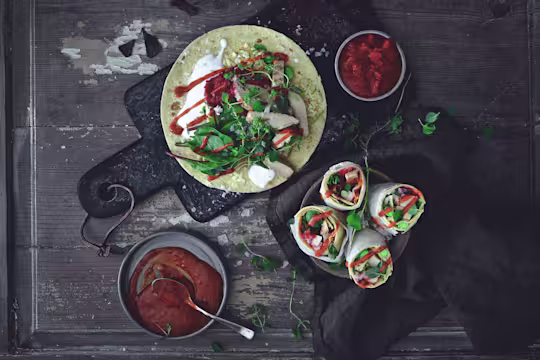 Easy vegetarian recipe made with Quorn Roast Mini Fillets served on top of a wrap next to bowls of sauce and finished wraps