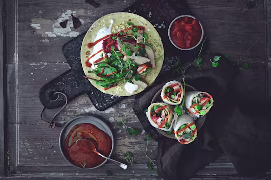Easy vegetarian recipe made with Quorn Roast Mini Fillets served on top of a wrap next to bowls of sauce and finished wraps