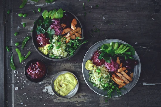 Salad bowl and plate with Quorn Roast Mini Fillets, bulgur, avocado, kidney beans, pickled onion and beetroot hummus