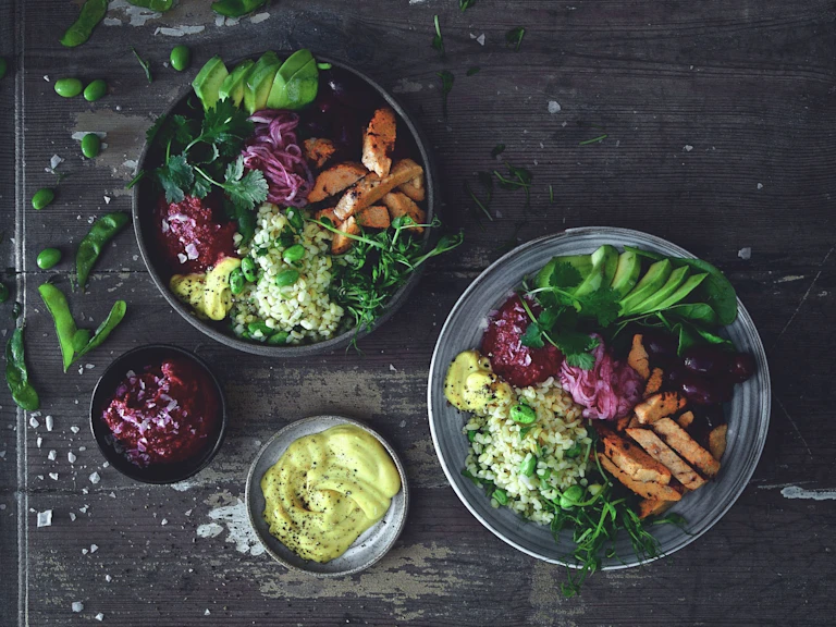 Salad bowl and plate with Quorn Roast Mini Fillets, bulgur, avocado, kidney beans, pickled onion and beetroot hummus