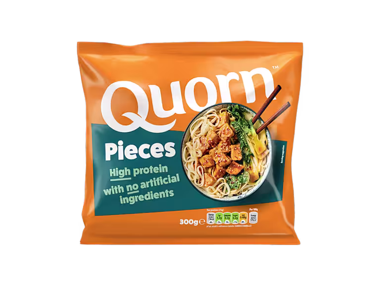 A bag of Quorn Pieces showing the prepared product and information on an orange and charcoal background.