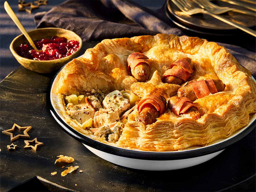 A Vegetarian Chicken & Stuffing Festive Pie, made with Quorn Pieces, on a black background.