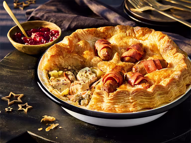 A Vegetarian Chicken & Stuffing Festive Pie, made with Quorn Pieces, on a black background.