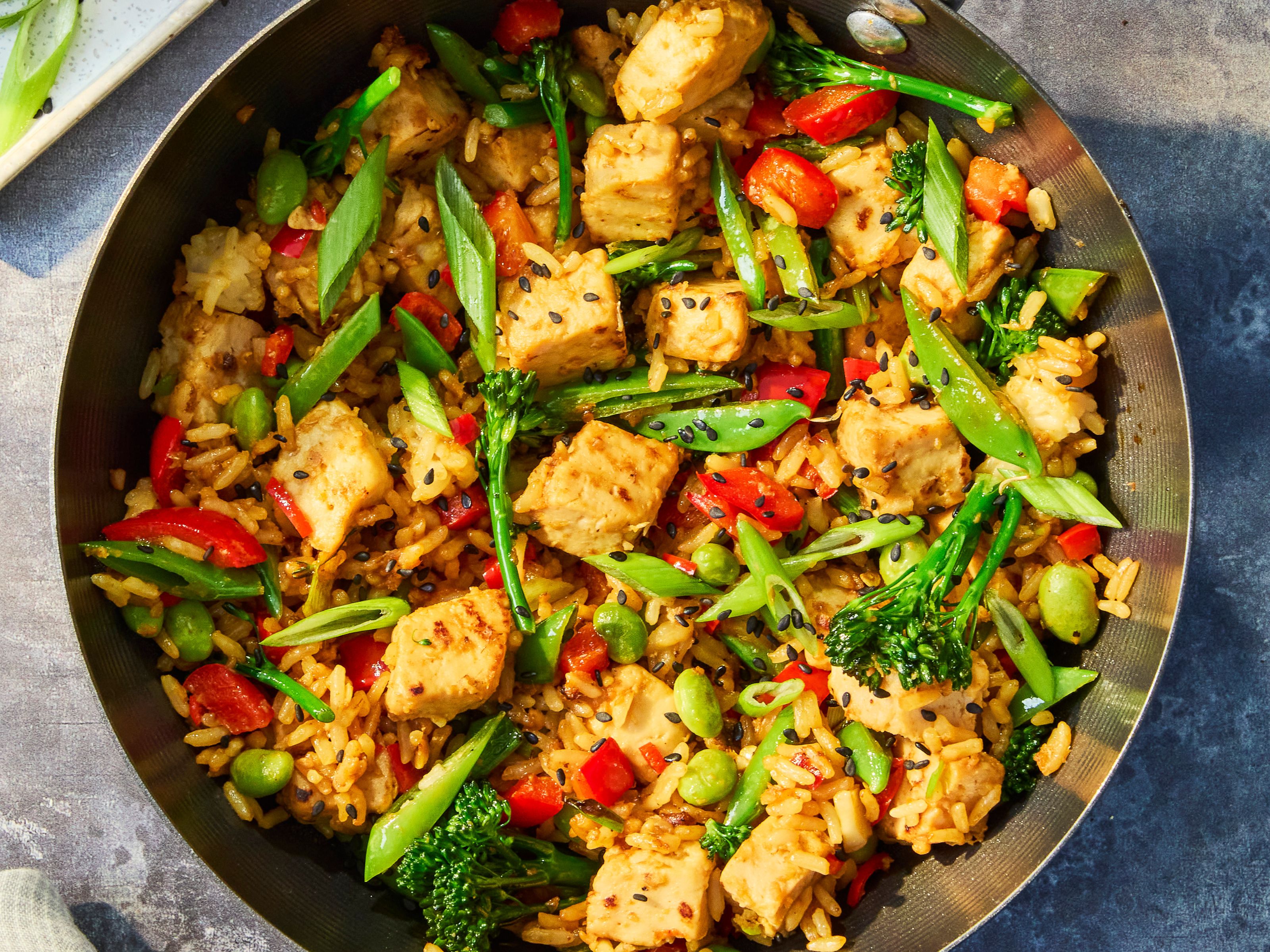 Vegetarian Quorn Fried Rice with Quorn Pieces, mixed vegetables, brown rice and spring onions served in a wok with lime and soy sauce.