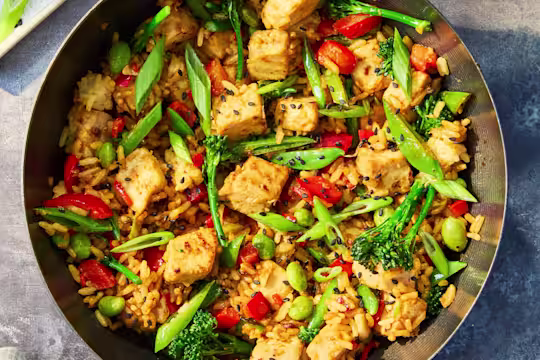 Vegetarian Quorn Fried Rice with Quorn Pieces, mixed vegetables, brown rice and spring onions served in a wok with lime and soy sauce.