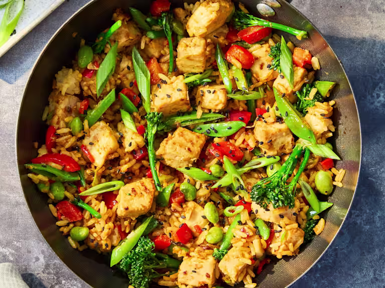 Vegetarian Quorn Fried Rice with Quorn Pieces, mixed vegetables, brown rice and spring onions served in a wok with lime and soy sauce.