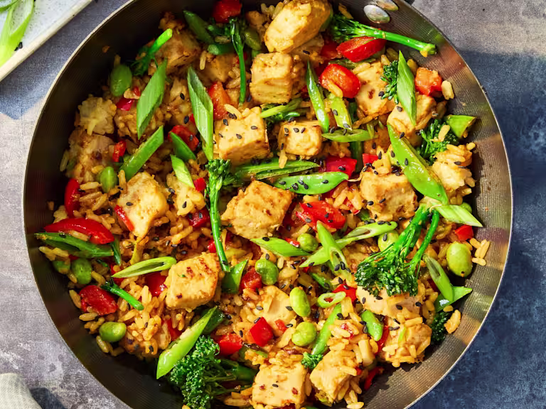 Vegetarian Quorn Fried Rice with Quorn Pieces, mixed vegetables, brown rice and spring onions served in a wok with lime and soy sauce.