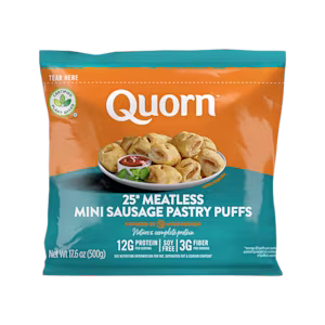 Quorn Vegan Mini Sausage Rolls on a baking tray next to a bowl of tomato ketchup.