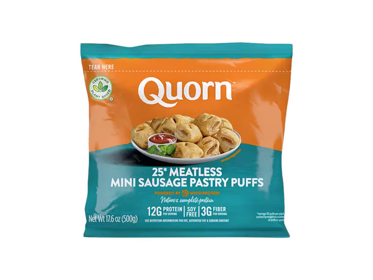 Quorn Vegan Mini Sausage Rolls on a baking tray next to a bowl of tomato ketchup.