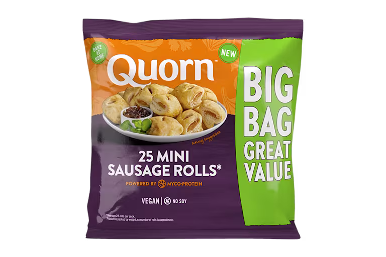 Quorn Vegan Mini Sausage Rolls on a baking tray next to a bowl of tomato ketchup.