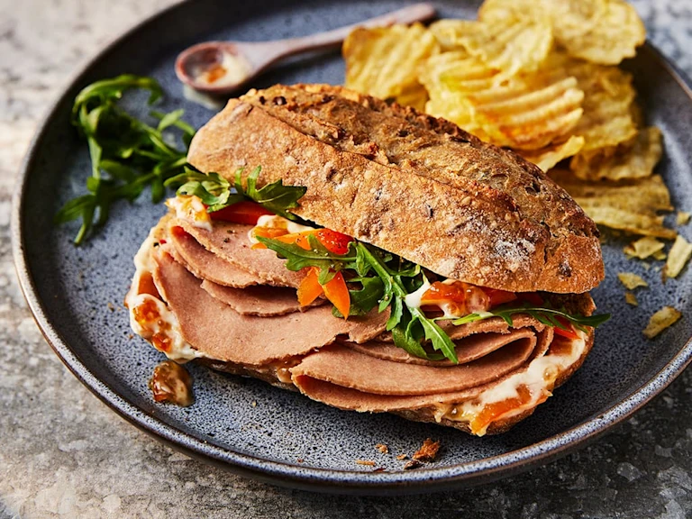 Yorkshire Ham Sandwich With Marmalade Crème Fraiche featuring Quorn Yorkshire Ham Style Slices and served with a slide of crisps.