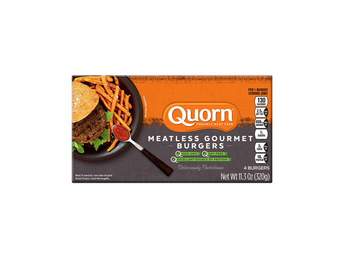 A box of Quorn Meatless Gourmet Burgers showing the product and the product information on an orange and charcoal background.