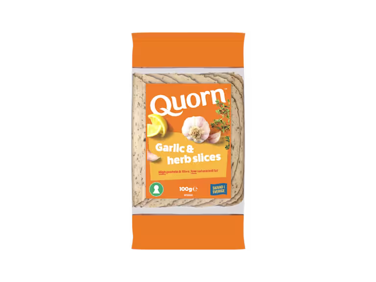Orange Quorn Garlic & Herb Slices peel and reseal packaging, with a blue new product label and serving suggestion of lemon, shredded lettuce and garlic.