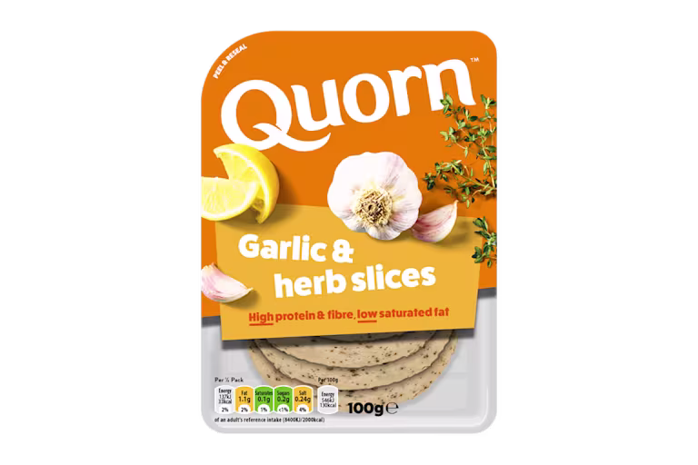 Orange Quorn Garlic & Herb Slices peel and reseal packaging, with a blue new product label and serving suggestion of lemon, shredded lettuce and garlic.