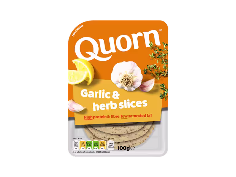 Orange Quorn Garlic & Herb Slices peel and reseal packaging, with a blue new product label and serving suggestion of lemon, shredded lettuce and garlic.