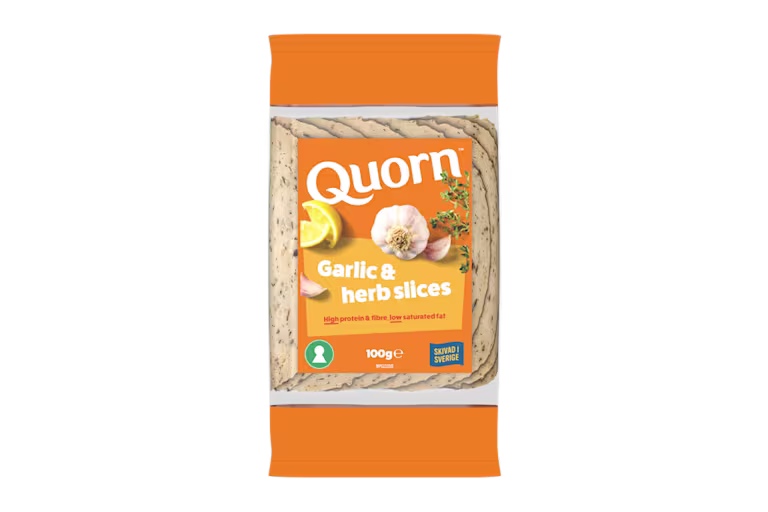 Orange Quorn Garlic & Herb Slices peel and reseal packaging, with a blue new product label and serving suggestion of lemon, shredded lettuce and garlic.