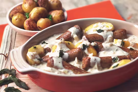 Quorn Vegetarian Sausage Casserole with cream, made with Quorn Sausages, apple, cider, onion and potatoes, served in a casserole dish