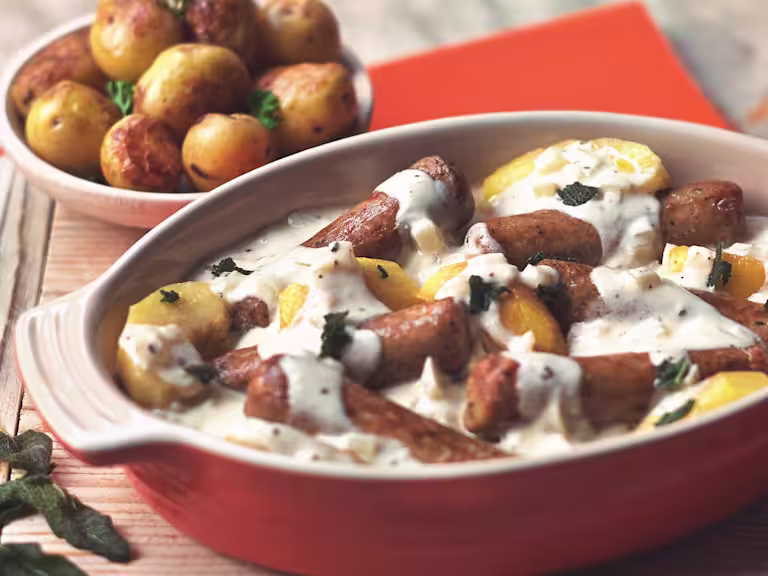 Quorn Vegetarian Sausage Casserole with cream, made with Quorn Sausages, apple, cider, onion and potatoes, served in a casserole dish