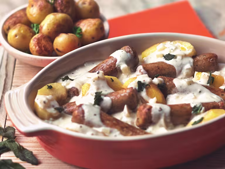 Quorn Vegetarian Sausage Casserole with cream, made with Quorn Sausages, apple, cider, onion and potatoes, served in a casserole dish