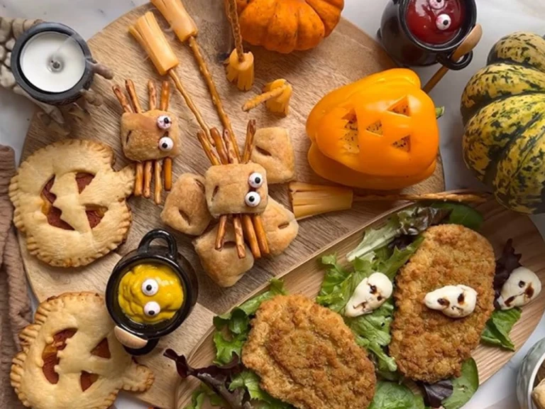 An assortment of foods including Mini Sausage Roll Spiders, Air Fryer Pumpkin Pizza Pies, Pumpkin Peppers and Quorn Tomato & Mozzarella Escalopes.