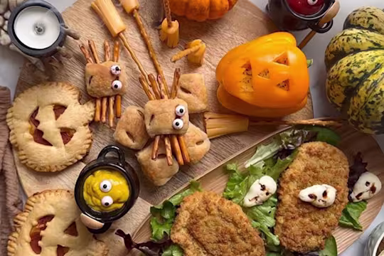 An assortment of foods including Mini Sausage Roll Spiders, Air Fryer Pumpkin Pizza Pies, Pumpkin Peppers and Quorn Tomato & Mozzarella Escalopes.