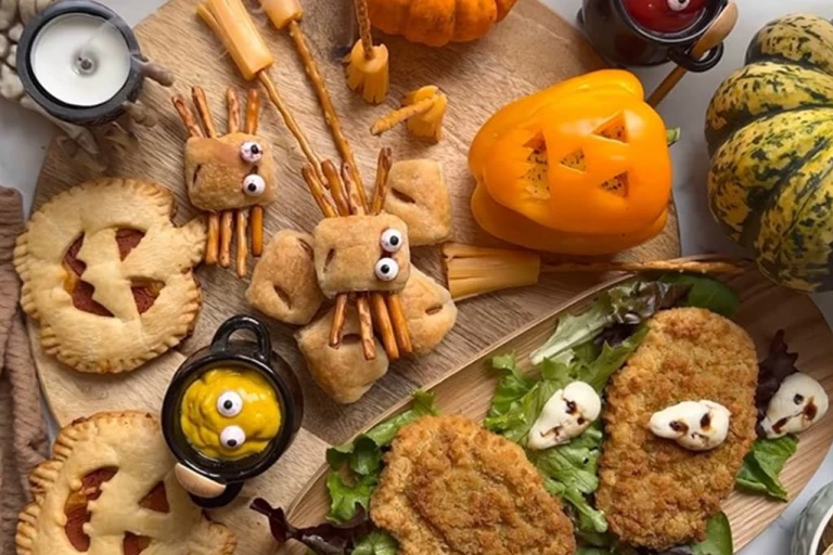 An assortment of foods including Mini Sausage Roll Spiders, Air Fryer Pumpkin Pizza Pies, Pumpkin Peppers and Quorn Tomato & Mozzarella Escalopes.