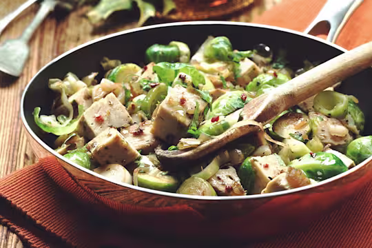 Quorn Roast, Brussels sprouts, leeks, and onion in a pan.