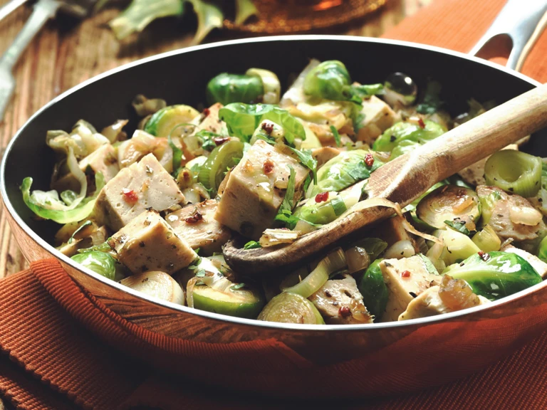 Quorn Roast, Brussels sprouts, leeks, and onion in a pan.