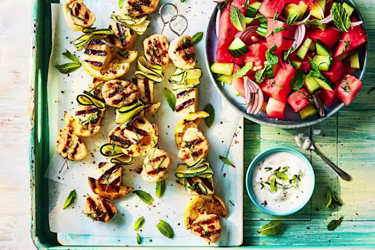 Four Quorn Fillet Pieces and Halloumi veggie skewers served alongside a watermelon salad.