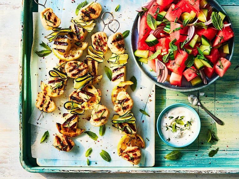 Four Quorn Fillet Pieces and Halloumi veggie skewers served alongside a watermelon salad.