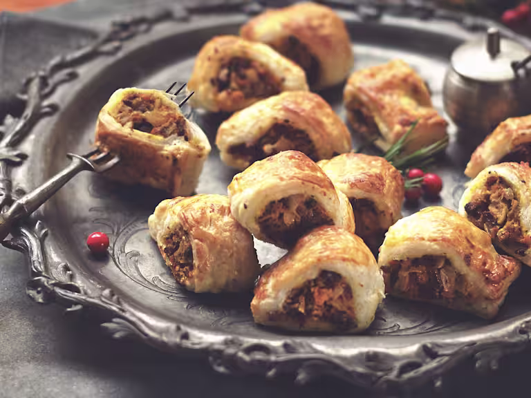 A serving plate with butternut squash sausage rolls with Quorn mince.