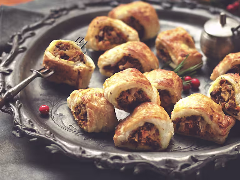 A serving plate with butternut squash sausage rolls with Quorn mince.