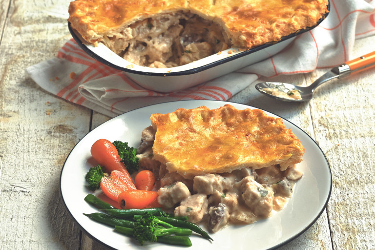 Vegetarian recipe of Quorn Gluten Free Pieces and mushroom pie served with carrots, broccoli and green beans in a white dish