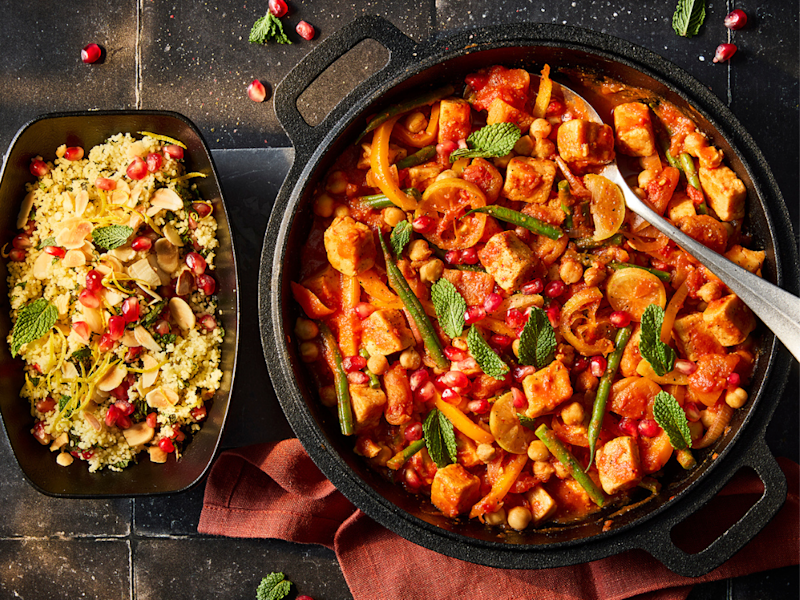 Moroccan Stew with Quorn Pieces, chickpeas and fresh vegetables in a serving dish with a side of cous cous.