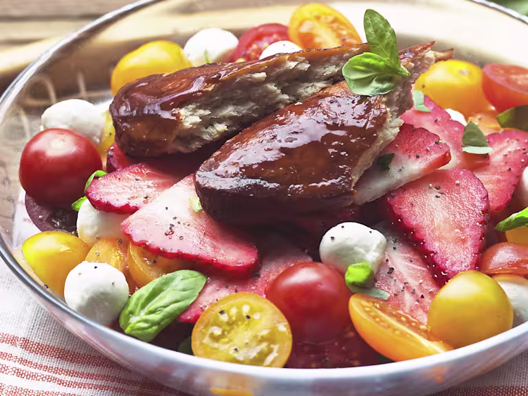 Pimm’s glazed Quorn fillets served on a fresh summer salad with strawberries tomatoes mozzarella and basil