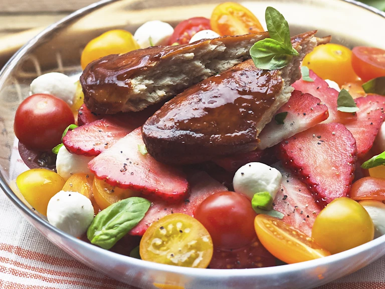 Pimm’s glazed Quorn fillets served on a fresh summer salad with strawberries tomatoes mozzarella and basil