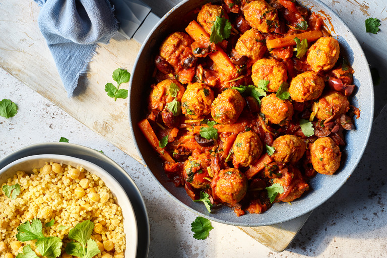 Spiced Quorn meatless meatball tagine with bulgur wheat and chickpeas served in two bowls. 
