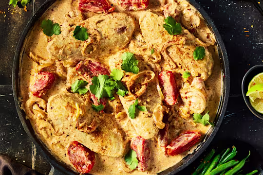 Quorn Fillets in a Cajun sauce with tomatoes and fresh herb garnish.