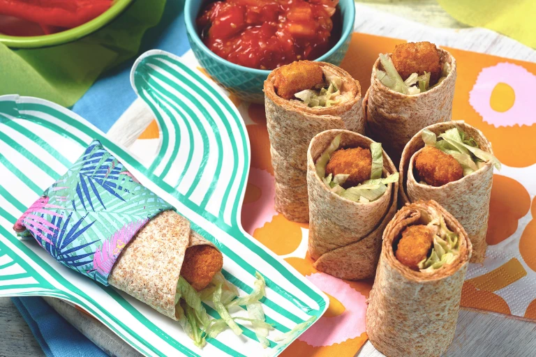 A table set with Quorn Fishless Finger Wrap Bites and a bowl of tomato ketchup.
