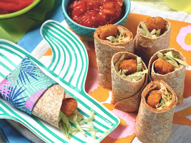 A table set with Quorn Fishless Finger Wrap Bites and a bowl of tomato ketchup.