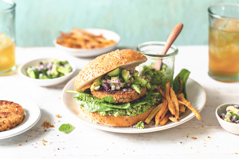 Veggie burger recipe made with Quorn Burgers on top of lettuce garnished with onions, pineapple and mango salsa in a bun