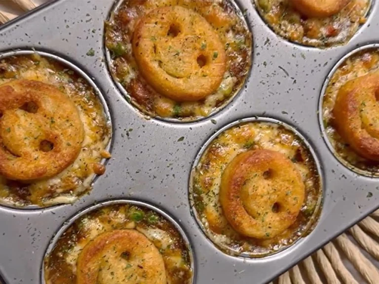 Several Smiley Face Mini Vegetarian Shepherd’s pies served in a baking tray.