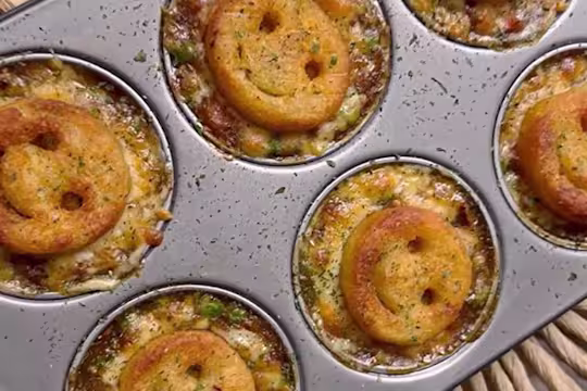 Several Smiley Face Mini Vegetarian Shepherd’s pies served in a baking tray.