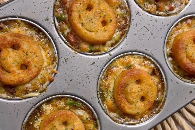 Several Smiley Face Mini Vegetarian Shepherd’s pies served in a baking tray.